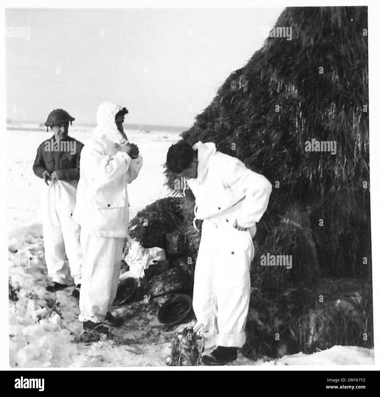 'SHOW SUITS' FOR PATROLS - Donning their patrol suits:- L-R: Cpl M. Duncan of Chalf Farm, London Pte M Duffey, of Bellshill, Lanarkshire Pte W. Grant of Aberdeen , British Army, 21st Army Group Stock Photo