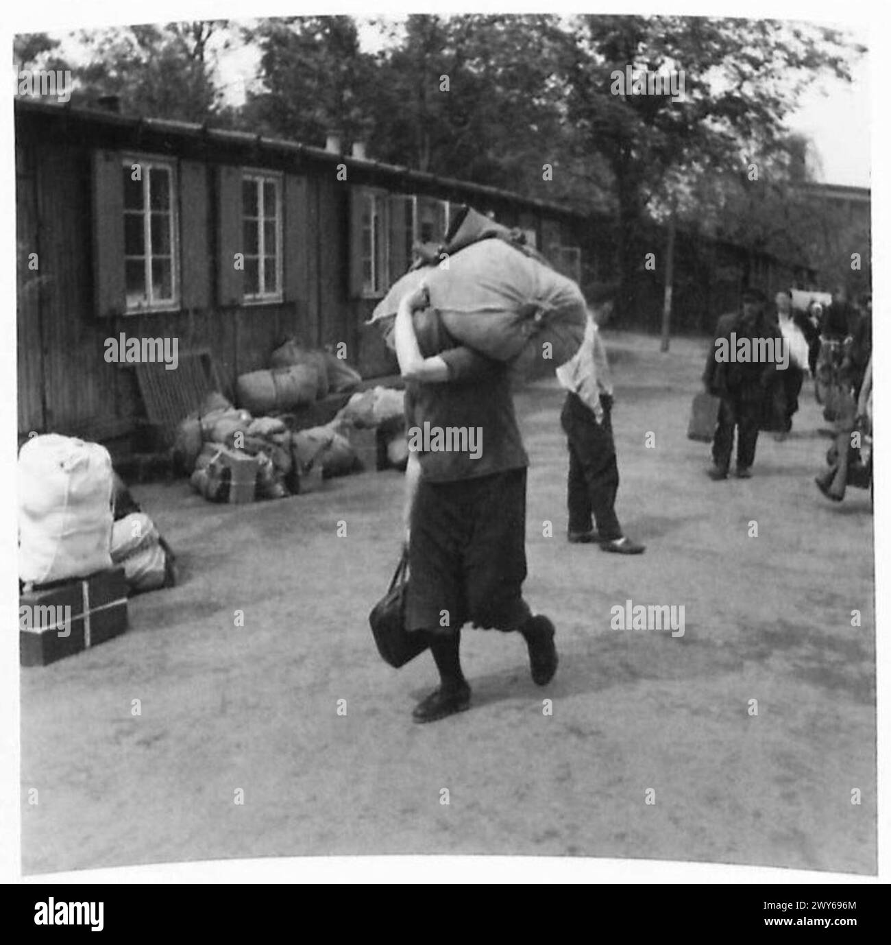 DISPLACED PERSONS CAMP IN HAMBURG ZOO - Russian woman carrying a huge ...