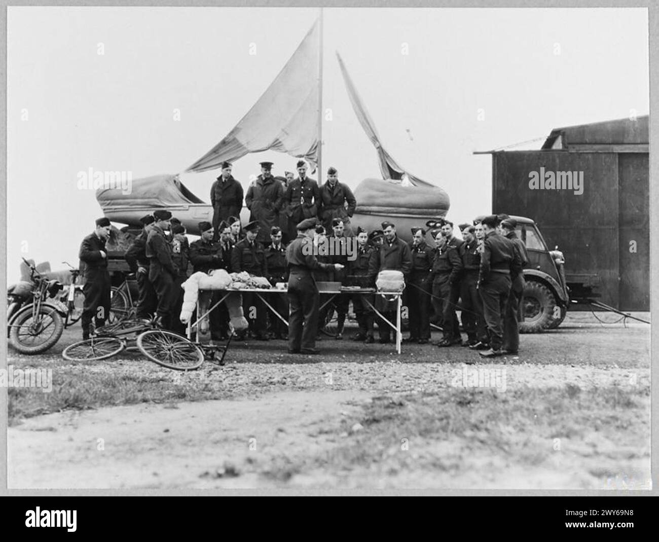 'AIRBORNE LIFEBOAT' DEMONSTRATED TO AIRCREWS - For story see CH.12911 Picture (issued 1944) shows - An Air/Sea Rescue expert demonstrates the equipment with which the airborne lifeboat is fitted. , Royal Air Force Stock Photo