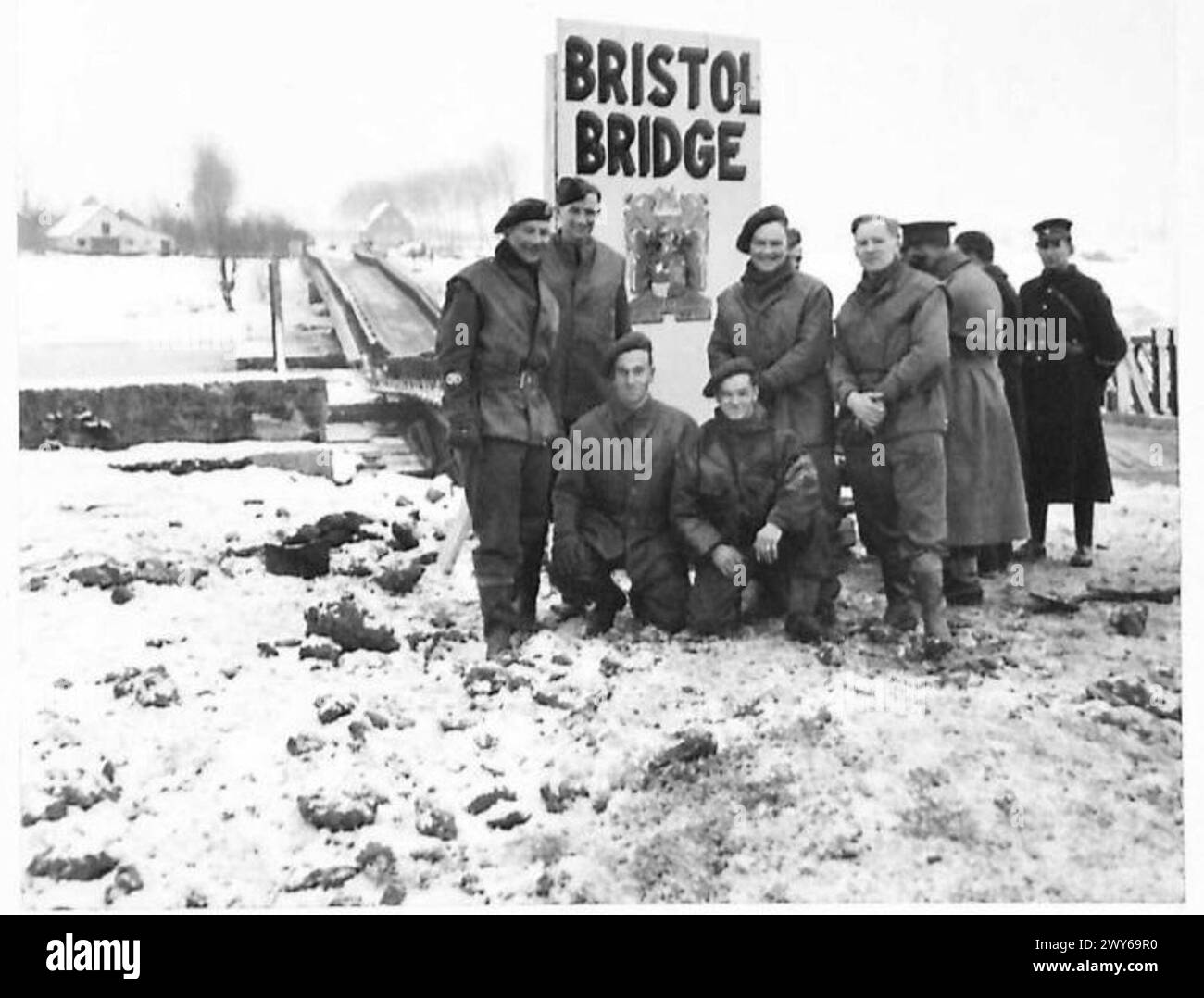 BRISTOL BRIDGE - The men from Bristol who built the Bristol Bridge stand by their finished job, L-R:- CSM Vowles of 14 Platts Hill, Kenysham Sjt D. Ricks of 190a Cranbrooke Road, Reland, Bristol 6 Sjt Greenslade of 3 Sandringham Avenue, Bristol Dcr J. T. Hunt of 26 Millington Brook Ave, Bristol 4 Spr K.J. Amery of 43 Bullen Road, Bristol Cpl E. James of 47 Weave St. Bristol 3 Ten minutes after the job was completed, the first supply column crossed the bridge on its way to the front. , British Army, 21st Army Group Stock Photo