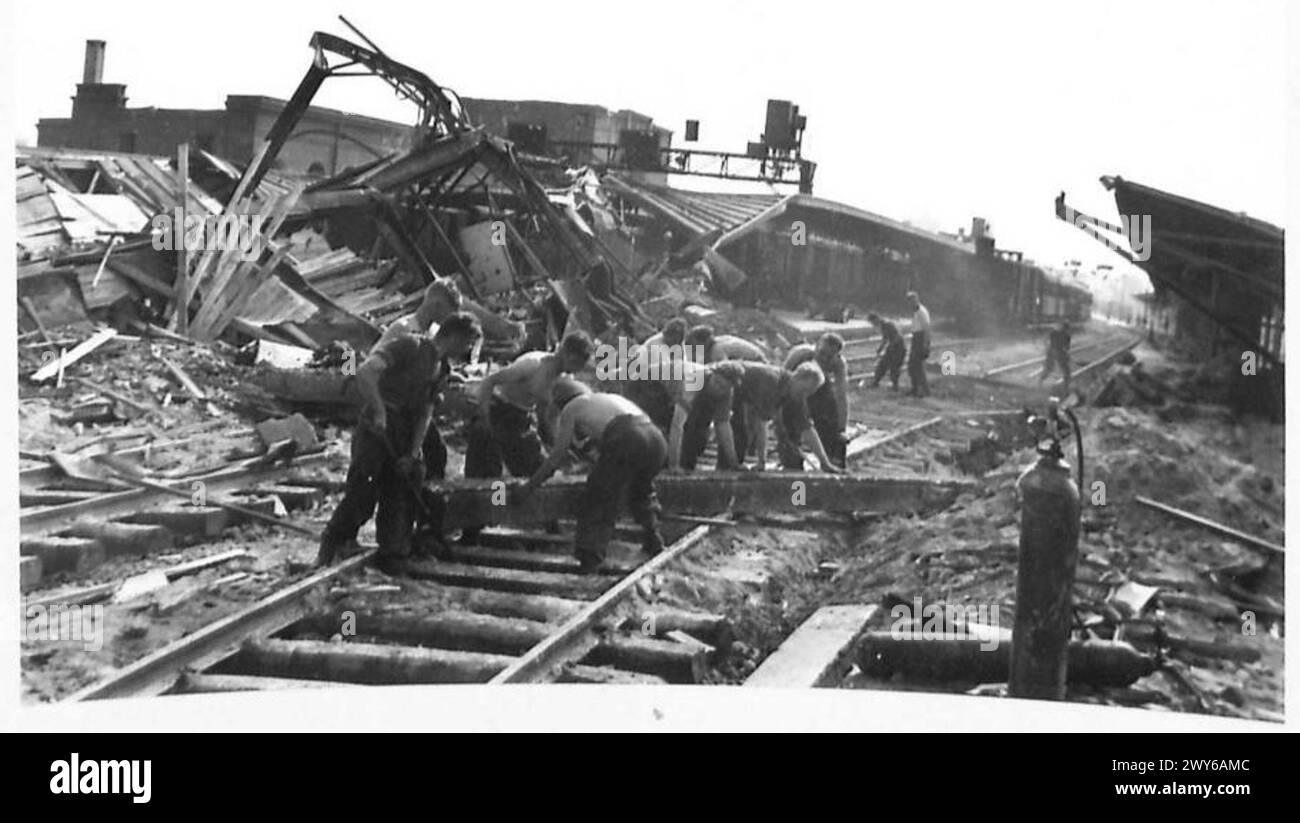 REPAIRING BOMB DAMAGE AT CAEN RAILWAY CENTRE - Royal Engineers at work on the permanent way. , British Army, 21st Army Group Stock Photo