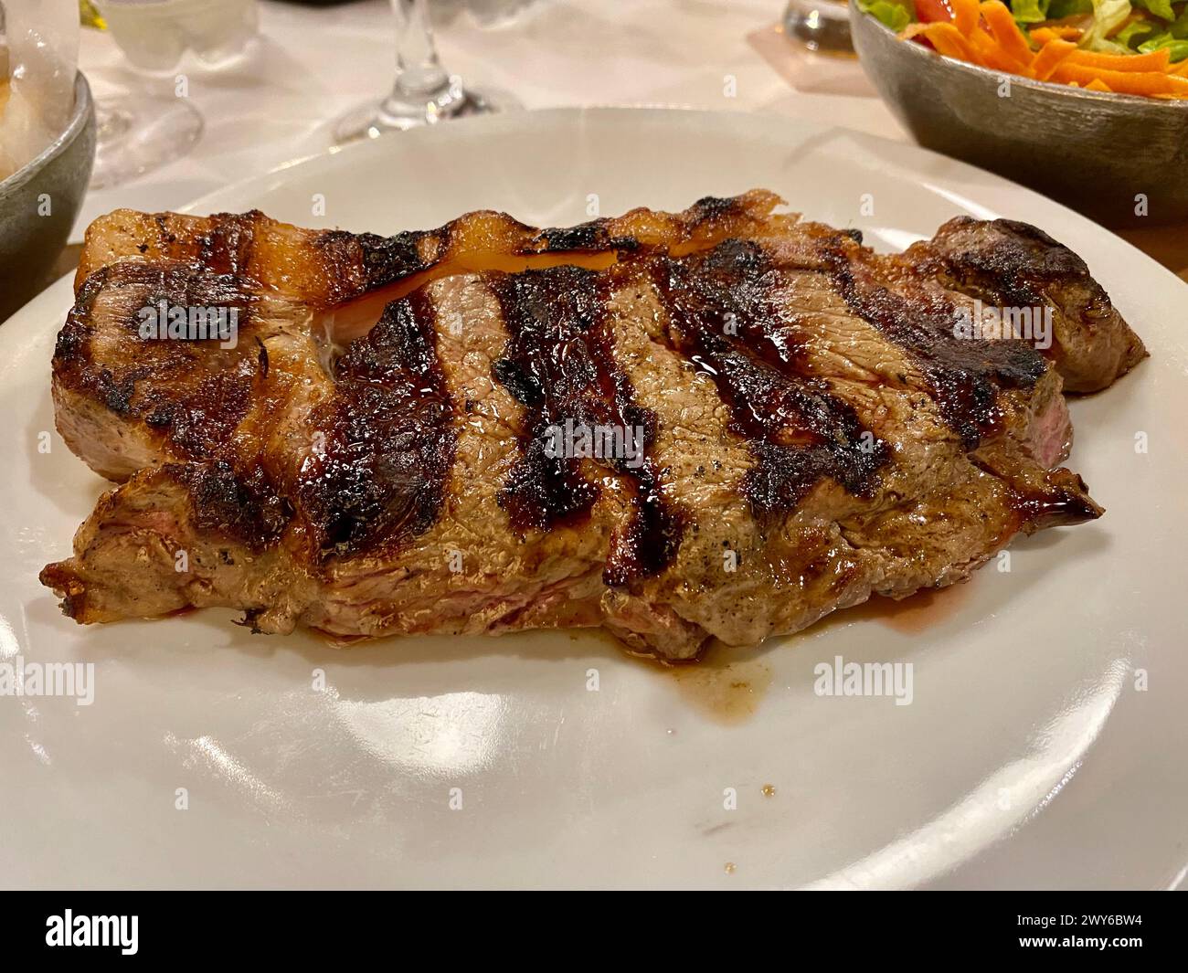 An amazing piece of grilled juicy Argentinian steak on a plate. Stock Photo