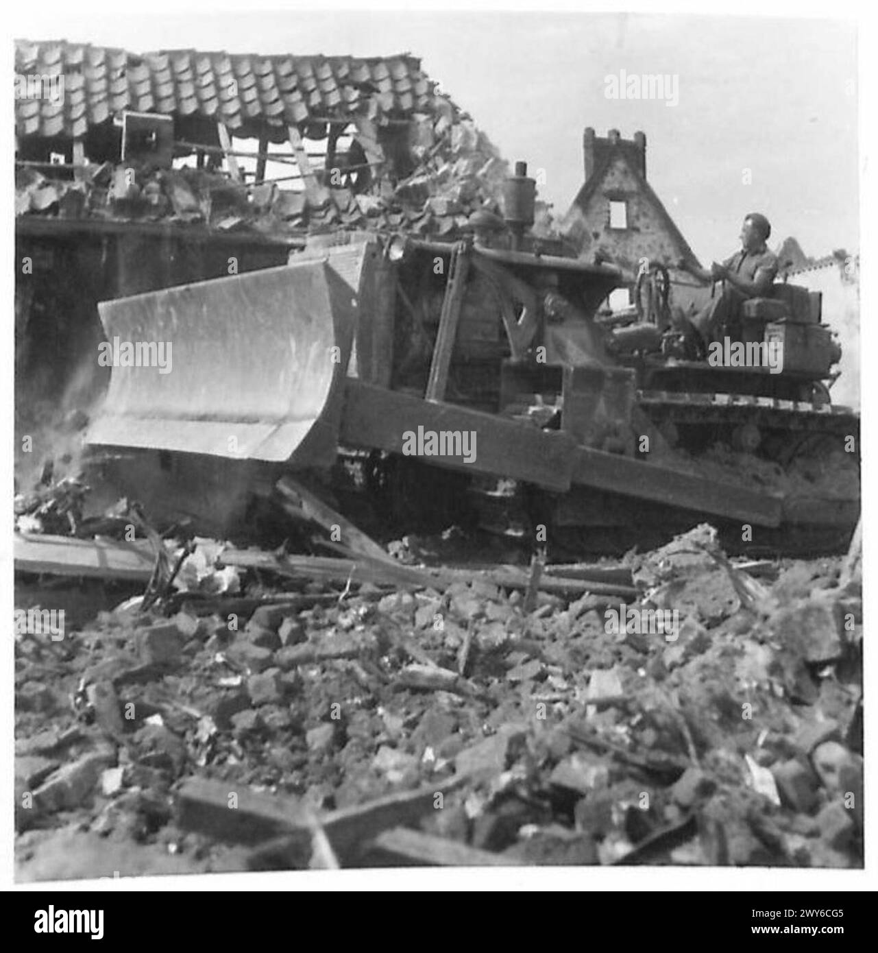 PERMANENT RHINE BRIDGES - Rubble being cleared by a bulldozer to make way for the bridge. , British Army, 21st Army Group Stock Photo