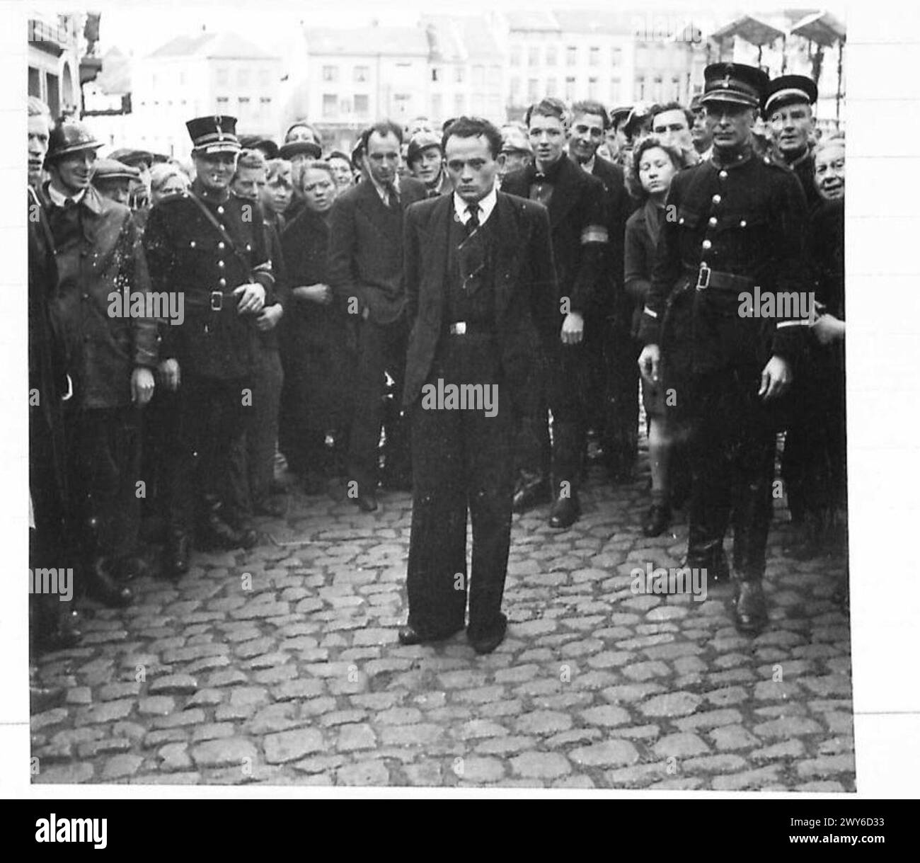 SCENES IN ANTWERP - Sunnaert Walter, a Belgian Quisling, who has been working for the Gestapo during German occupation, is brought through the Belgian town of Grammont handcuffed: he was captured by patriots after vain attempt to run away. Judging by his hangdog look he is fearful of the judgement of his former victims. , British Army, 21st Army Group Stock Photo