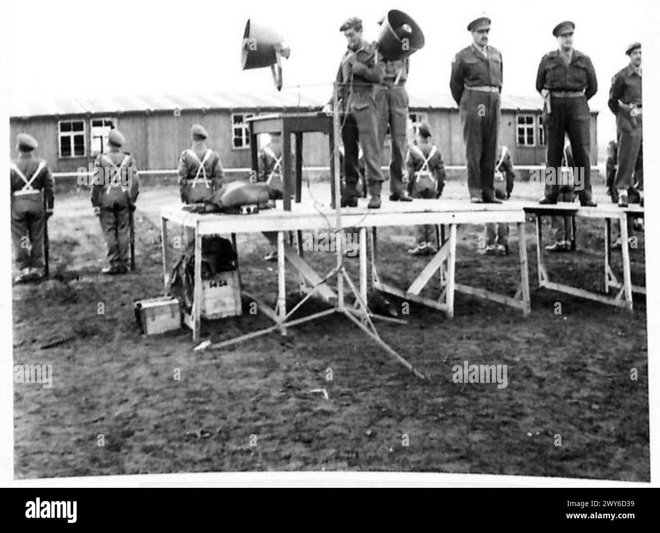 Colonel Bird addresses personnel before the last hut at Belsen Camp is ...