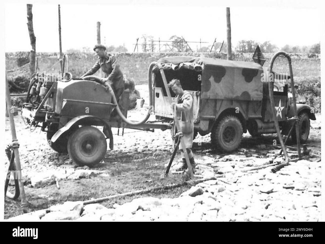 NORMANDY - VARIOUS - Water points have been set up at various points in the Normandy B 5669 bridgehead. At this water point at Creully, Driver S.H.Bevan of Rose Corrage, Osbaston, Monmouth, (right) comes to fill a water trailer from the pump operated by Sapper J.M.Gilmartin of 8 Commercial Street, Normanton, Yorks. Driver S.H.Bevan - 235 Field Park Company, RE. Sapper Gilmartin - 413 Field Company, RE. , British Army, 21st Army Group Stock Photo