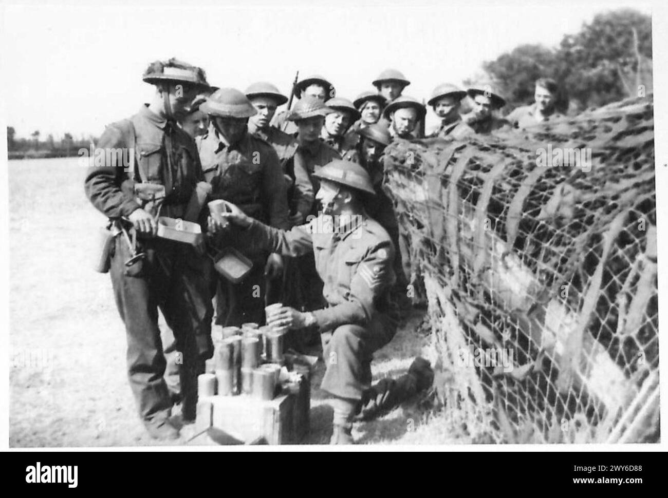 Daily Cooked Ration Troops in the Normandy bridgehead receive daily rations from Compo ...