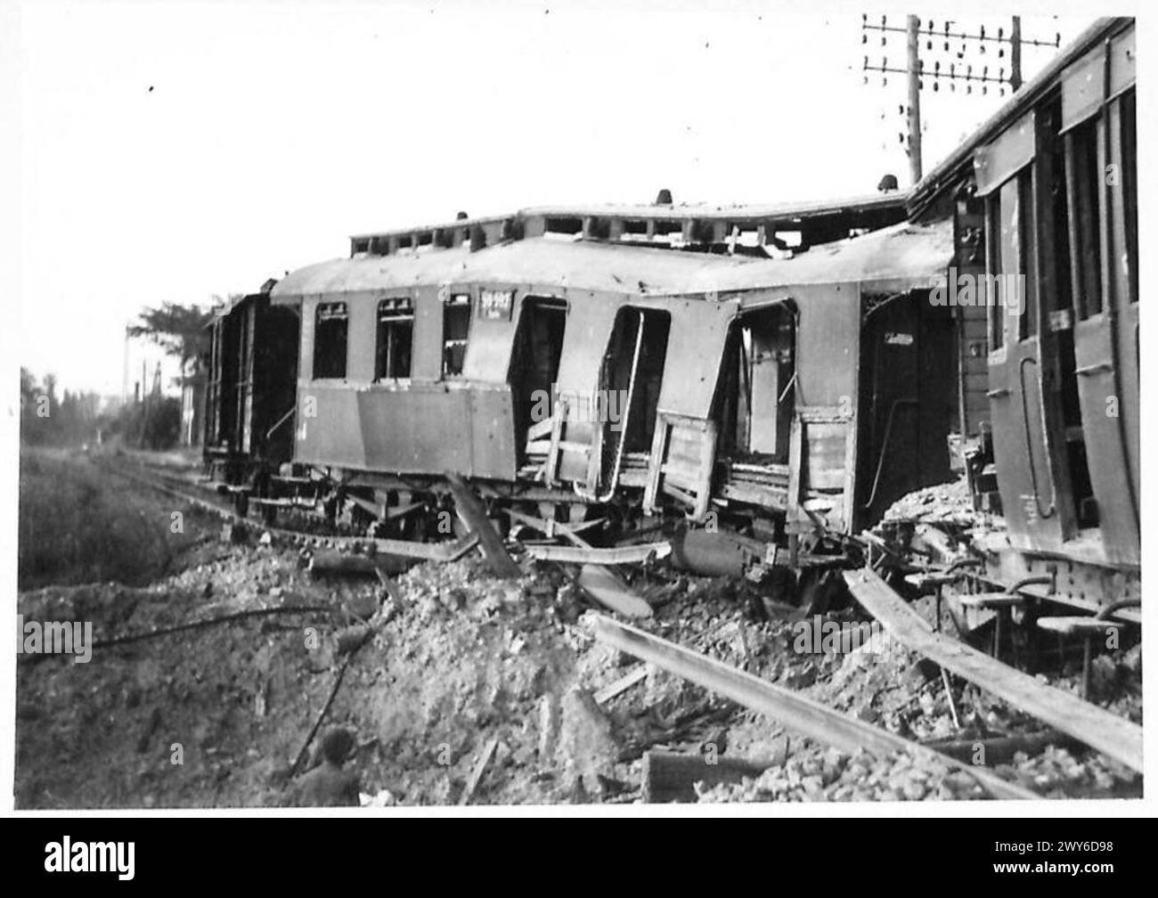 AFTER THE BOMBING AND THE SHELLING - Wrecked rolling stock and permanent way near the station. , British Army, 21st Army Group Stock Photo