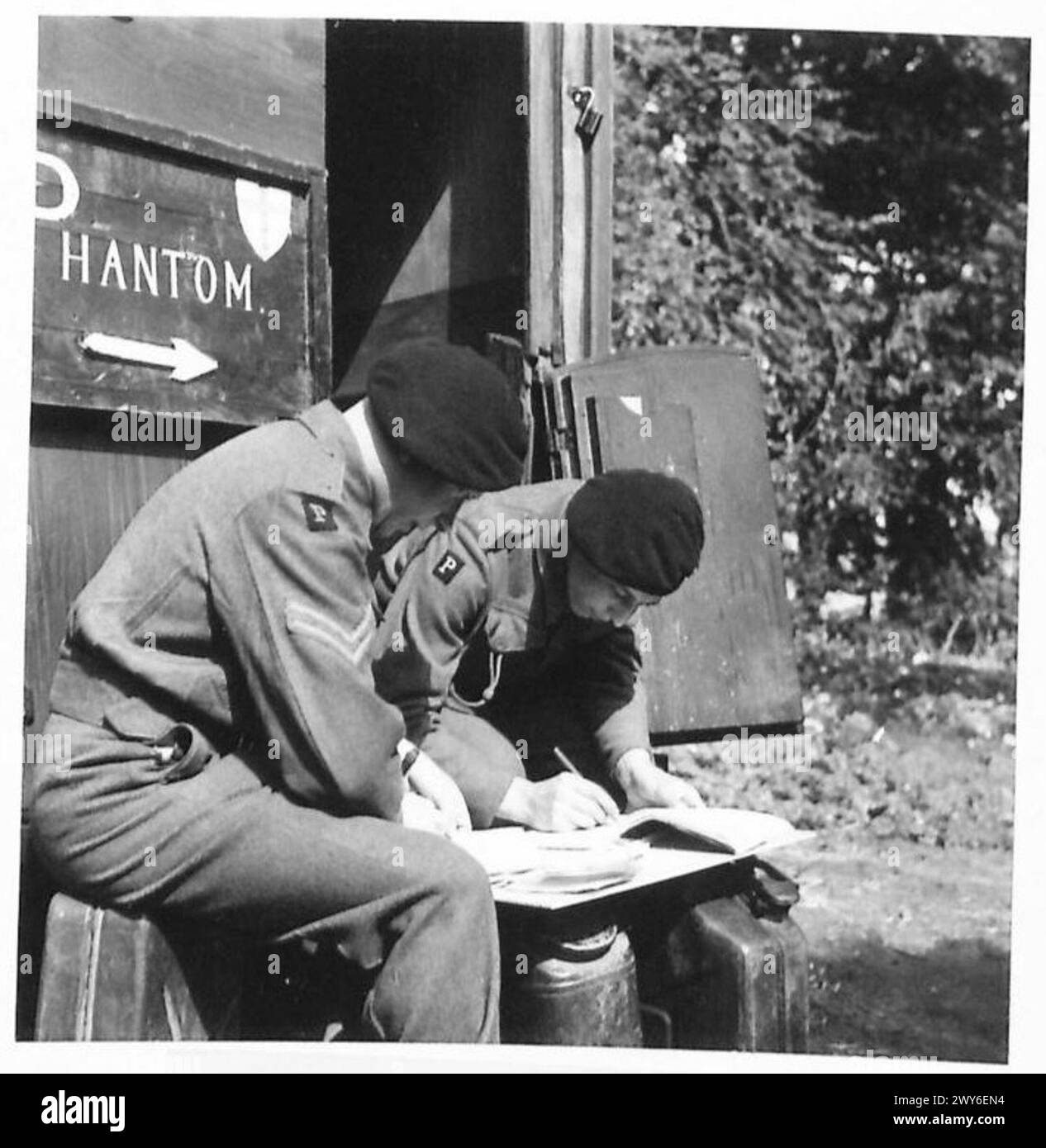 PHANTOM - Captain Gray having completed his mission writes a message for Sqn. H.Q. , British Army, 21st Army Group Stock Photo
