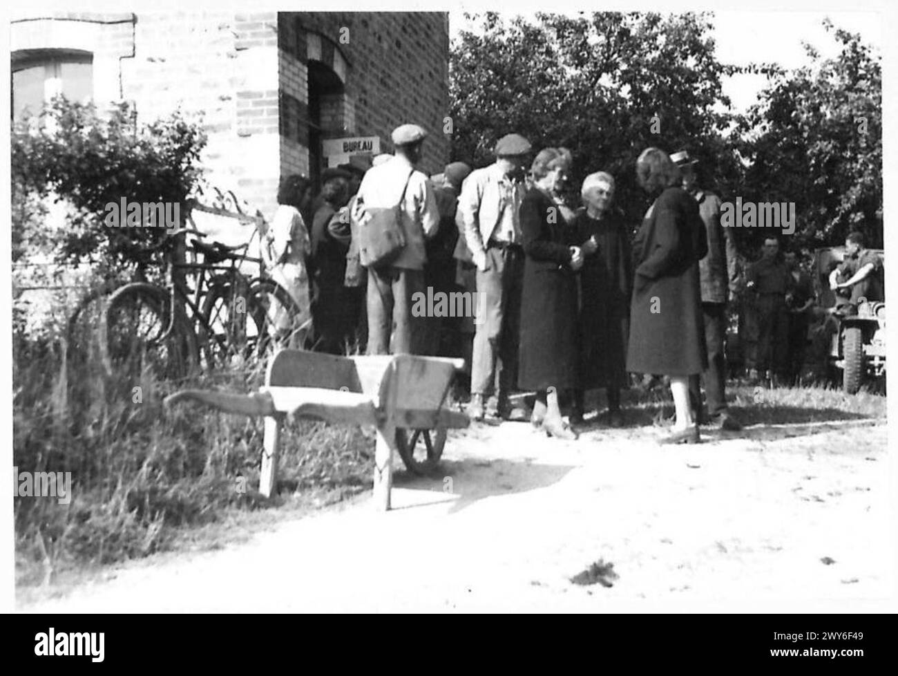 French villagers queue at a bureau in Normandy to register for food ...