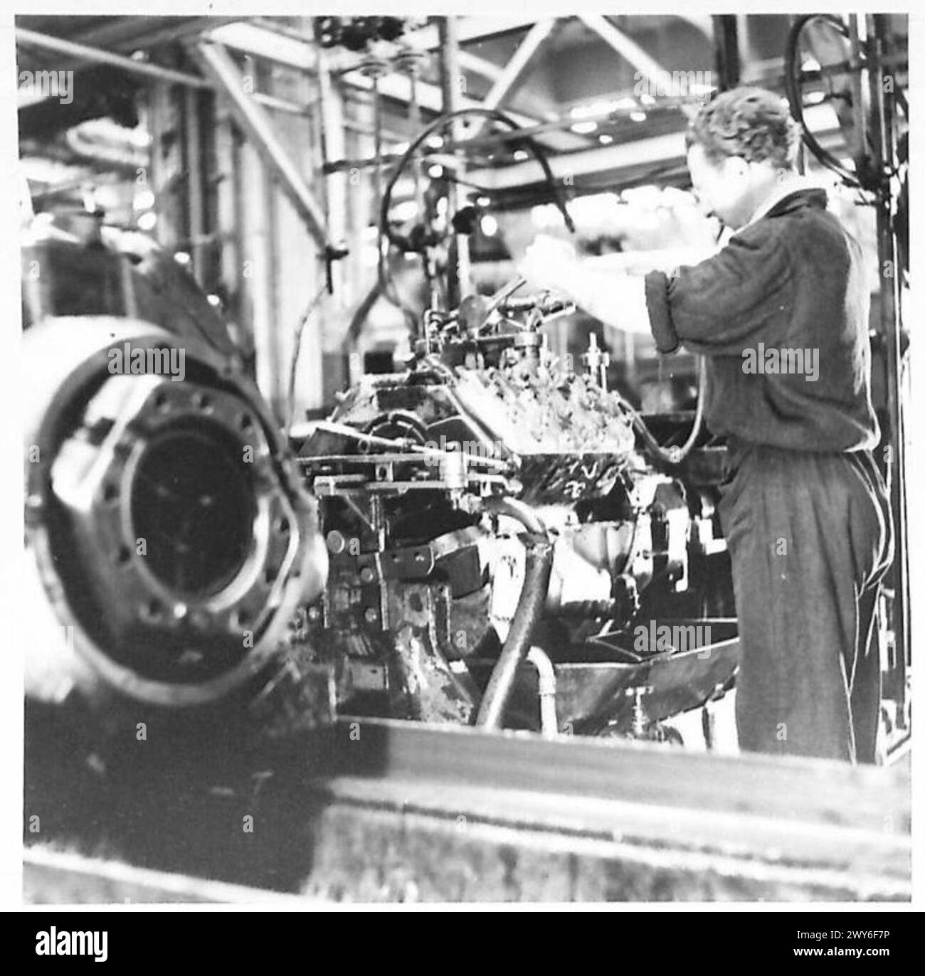 FORD WORKS AT COLOGNE - Once the engine has received its full complement of mechanical parts it is then run in a special bench. The propshaft is connected to an electrical motor, hot water is pumped through the cylinder block and it is left to run for a specified period, result is the engine is partially run in before it ever has petrol in it. , British Army of the Rhine Stock Photo