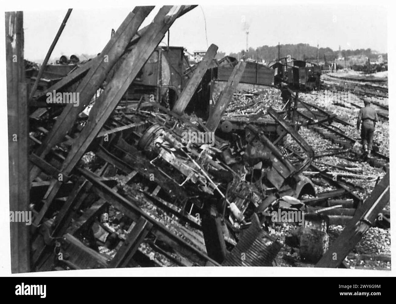 REPAIRING BOMB DAMAGE AT CAEN RAILWAY CENTRE - Damage to the goods wagons and permanent way in the goods yards. , British Army, 21st Army Group Stock Photo