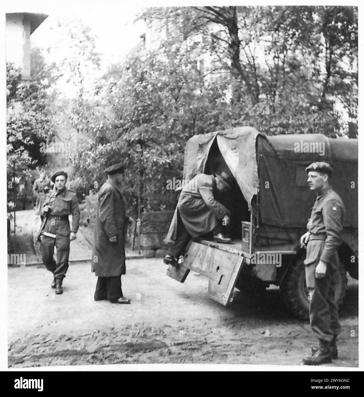 THE GREAT ROUND-UP - A bunch of ex-Gestapo Agents being herded into a truck at Flensburg for transportation to the Concentration Camp a few miles inside Denmark. , British Army, 21st Army Group Stock Photo