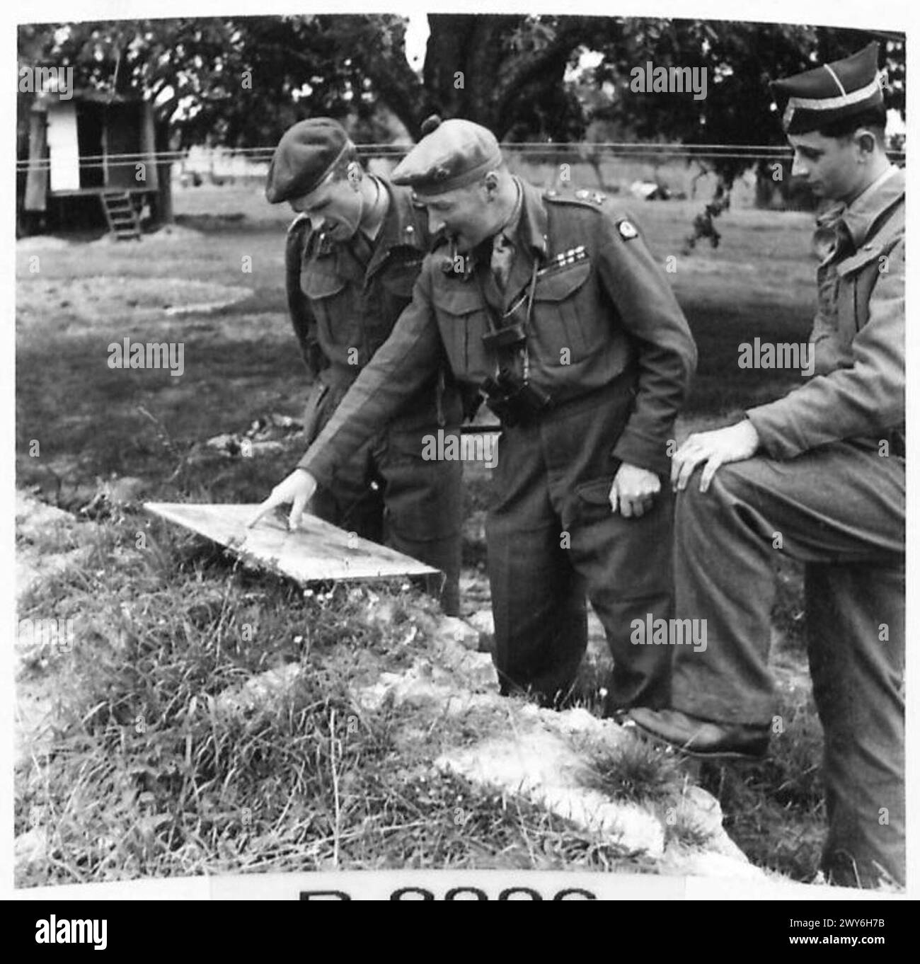 Lieutenant General N. M. Ritchie of the British Army examined a map ...