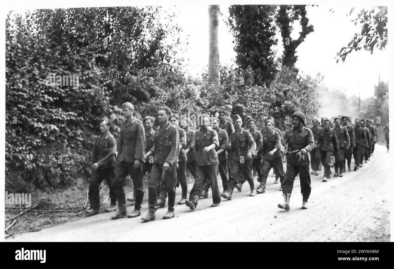 WITH THE BRITISH FORCES SOUTH OF CAUMONT - The remains of a German company who surrendered en bloc being marched in from the forward area. , British Army, 21st Army Group Stock Photo