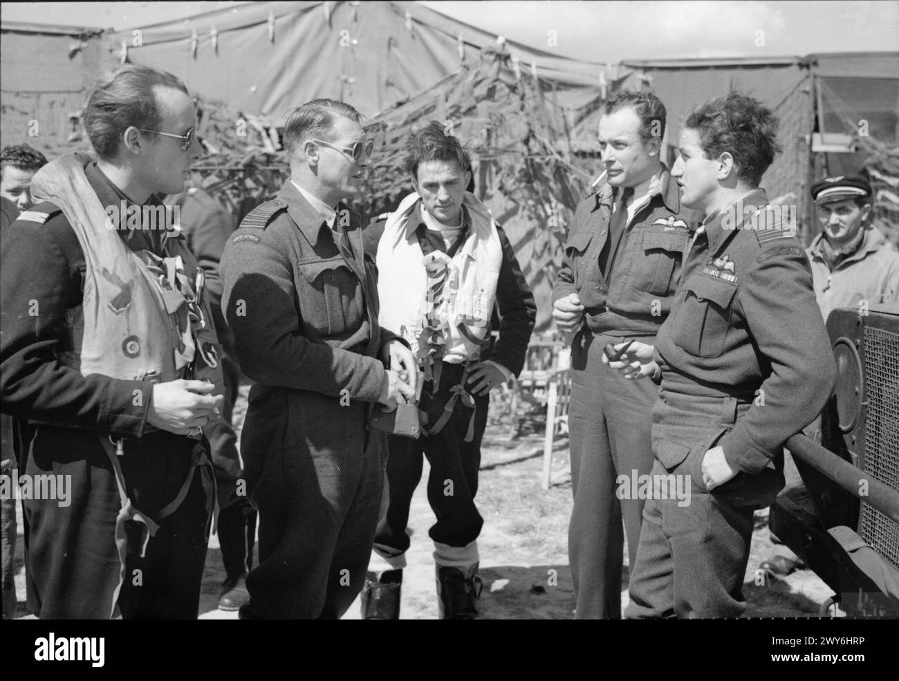 ROYAL AIR FORCE: 2ND TACTICAL AIR FORCE, 1943-1945 - Group Captain A G Malan (second from left), Commanding Officer of No 145 (Free French) Wing discusses the operational situation on the morning of 'D-Day' with some of his pilots at Merston, Sussex. On the left stands Free French pilot, Lieutenant Raoul Duval; second from the right is the Wing Leader, Wing Commander W V Crawford-Compton; third right is Commandant C Martell, Commanding Officer of No. 341 (Free French) Squadron RAF. , Malan, Adolph Gysbert, Royal Air Force, Maintenance Unit, 201 Stock Photo
