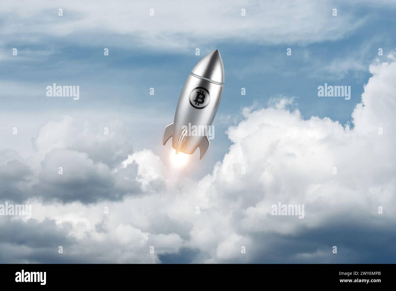 Silver rocket launch with a bitcoin sign on sky background. Minimal investment concept. Stock Photo