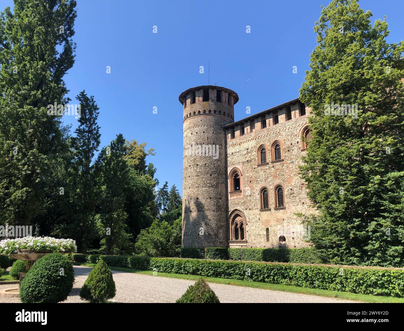 Grazzano Visconti, italy - june 11, 2023: view of medieval castle  in stone and bricks from the beautiful surrounding park in a day of summer Stock Photo