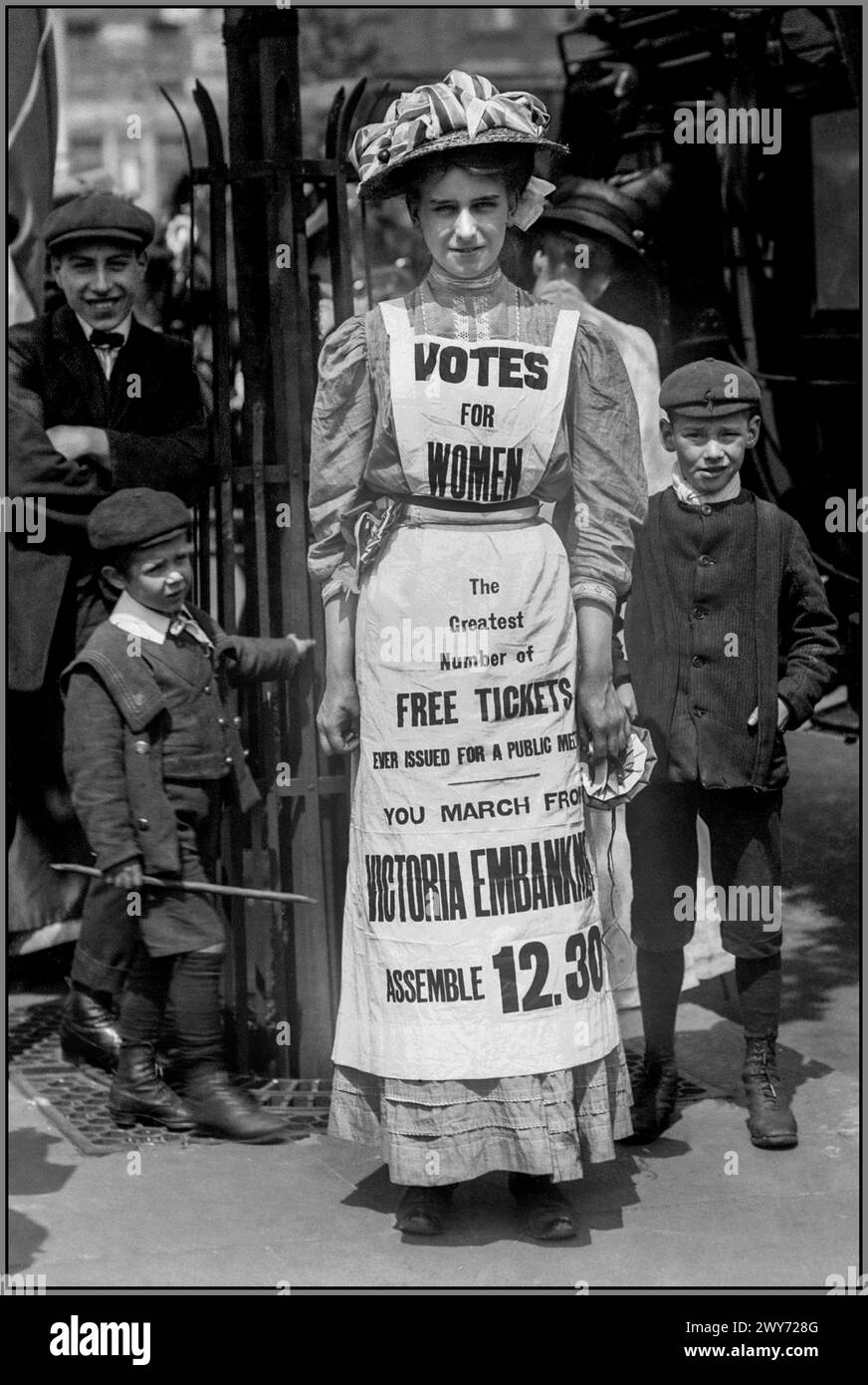 SUFFRAGETTE UK Votes for women London UK Suffragette movement. 1908 Vera Wentworth in the Strand London wearing a housemaids apron with 'VOTES FOR WOMEN' promoting a suffrage march from Victoria Embankment London.from 12.30 pm Stock Photo