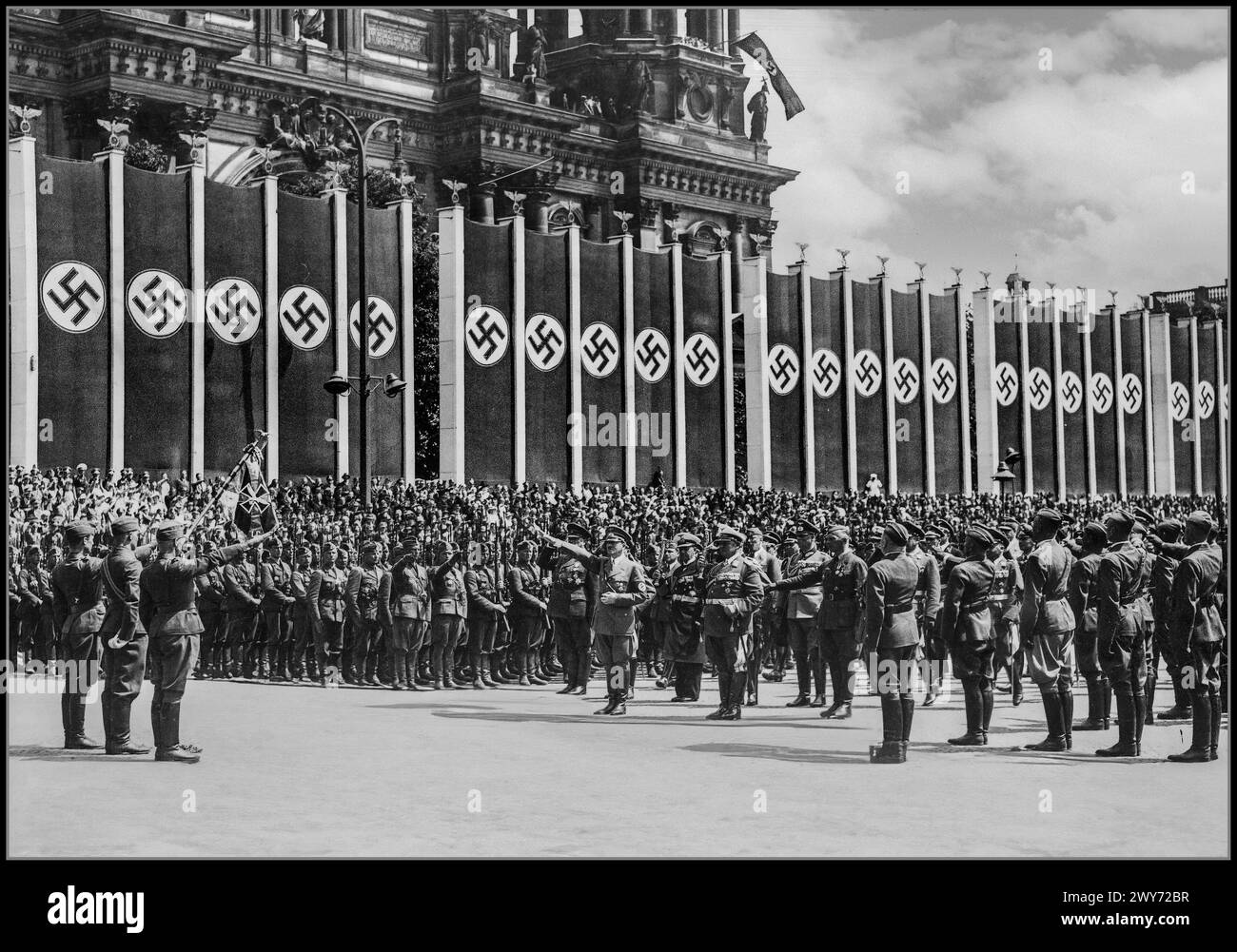 Adolf Hitler in Lustgarten salutes the banner of the Condor Legion. Next to him stand: General Hugo Sperrle (on the left), and on the right: Adm. Erich Raeder, Hermann Goering, General Wilhelm Keitel, General Wolfram von Richthofen. The Berlin Cathedral building can be seen in the background. Date 6 June 1939 Adolf Hitler salutes troops of the Condor Legion who fought alongside Spanish Nationalists in the Spanish civil war Berlin Nazi Germany Stock Photo