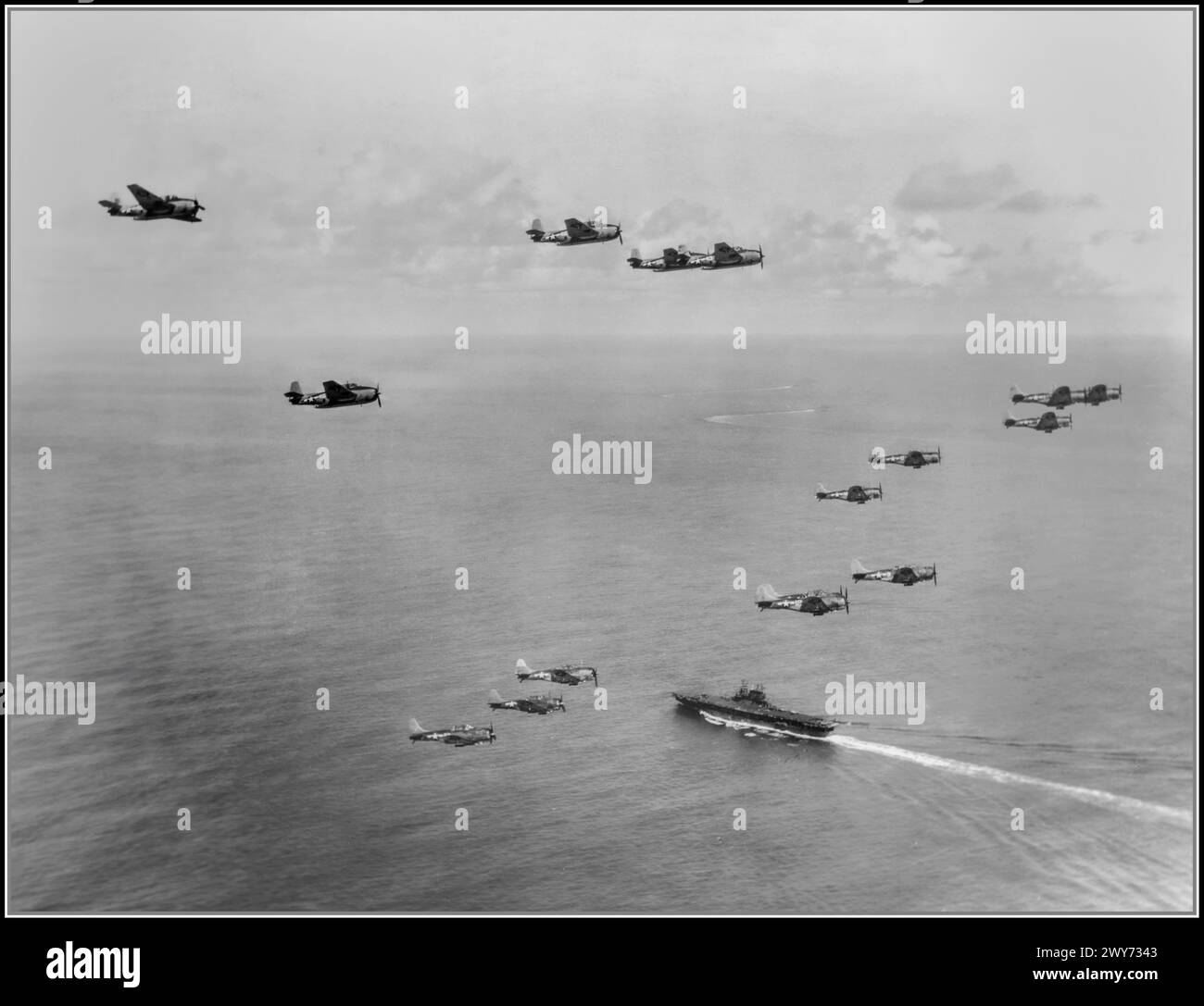 American torpedo bombers Grumman TBF-1 Avenger from the 10th torpedo squadron (Torpedo Squadron 10, VT-10) and eleven Douglas SBD-5 Dauntless dive bombers from Bombing Squadron 10 (VB-10) fly over the aircraft carrier USS Enterprise (CV-6) to strike Palau. Both squadrons were part of Carrier Air Group 10 (CVG-10), based on the Enterprise from January to July 1944. The Battle of Peleliu, codenamed Operation Stalemate II by the US military, was fought between the United States and Japan during the Mariana and Palau Islands campaign of World War II, from 15 September to 27 November 1944, Stock Photo