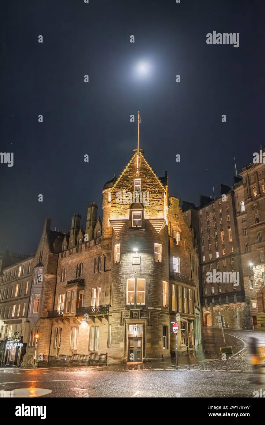 A night scene of old buildings on the corner of Market Street and Cockburn Street, under the moon. Edinburgh, Scotland Stock Photo