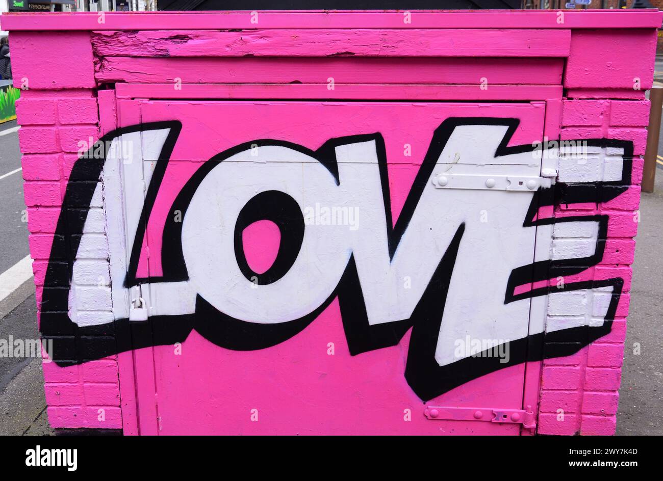 Painted love message on street furniture in Stephenson Square, central Manchester, UK Stock Photo