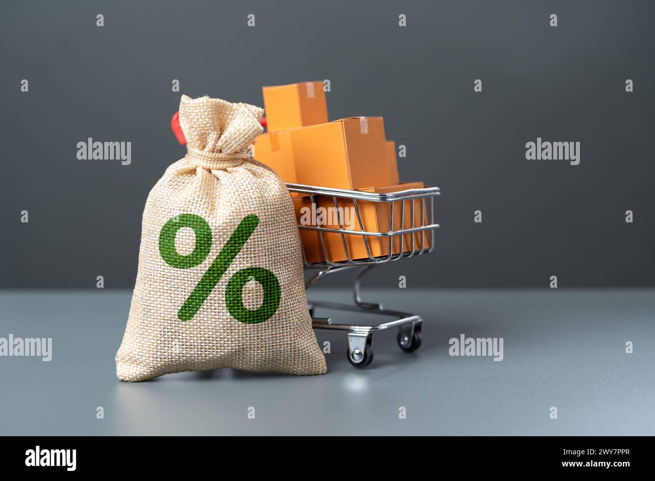 A bag with interest and a shopping cart with goods. Purchase on credit. Discounts and promotions. Purchasing power of buyers. Paying taxes. Savings on Stock Photo