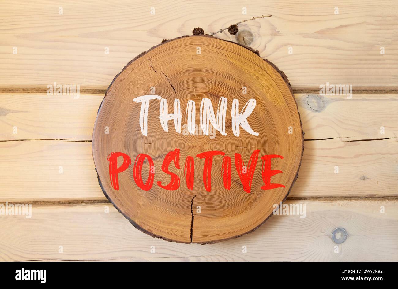 Think positive symbol. Concept words Think positive on beautiful wooden circle. Beautiful wooden wall background. Business, motivational think positiv Stock Photo