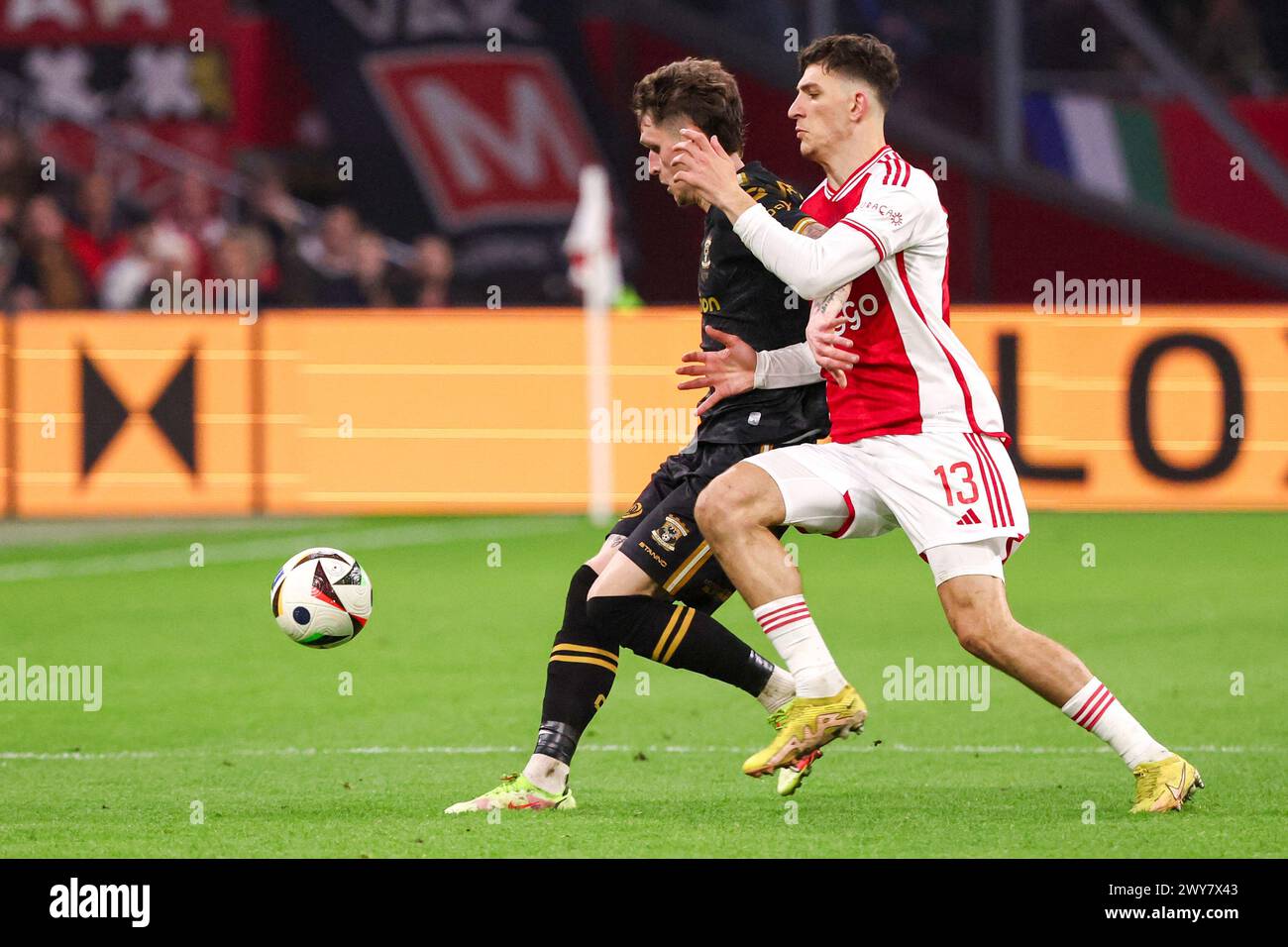 Amsterdam, Netherlands. 04th Apr, 2024. AMSTERDAM, NETHERLANDS - APRIL 4: Thibo Baeten of Go Ahead Eagles battles for possession with Ahmetcan Kaplan of AFC Ajax during the Dutch Eredivisie match between AFC Ajax and Go Ahead Eagles at Johan Cruijff ArenA on April 4, 2024 in Amsterdam, Netherlands. (Photo by Henny Meyerink/BSR Agency) Credit: BSR Agency/Alamy Live News Stock Photo