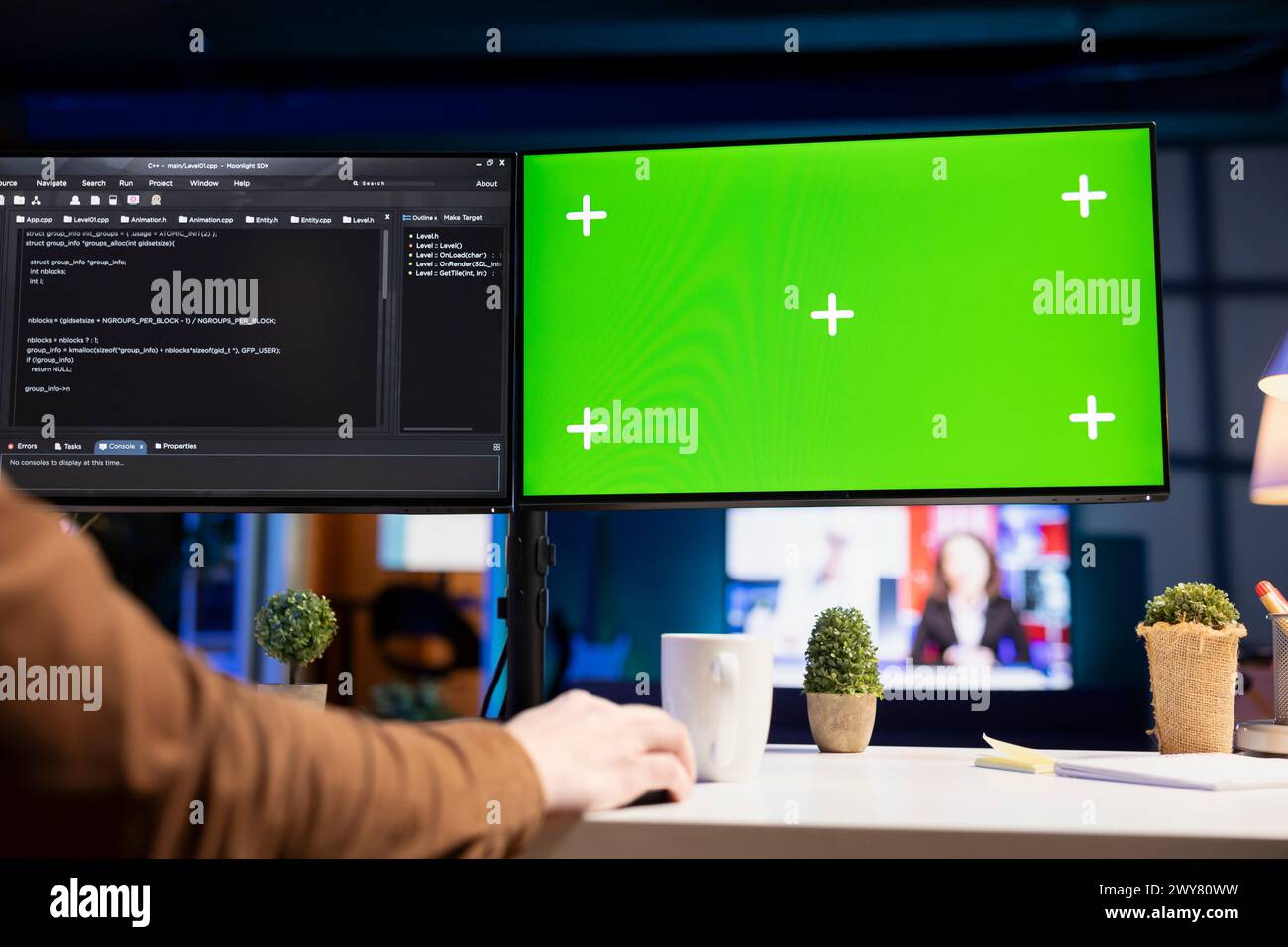 Developer doing software debugging on isolated screen PC at home, checking wrong lines of code displayed on monitors. IT professional in living room fixing coding problems on chroma key computer Stock Photo