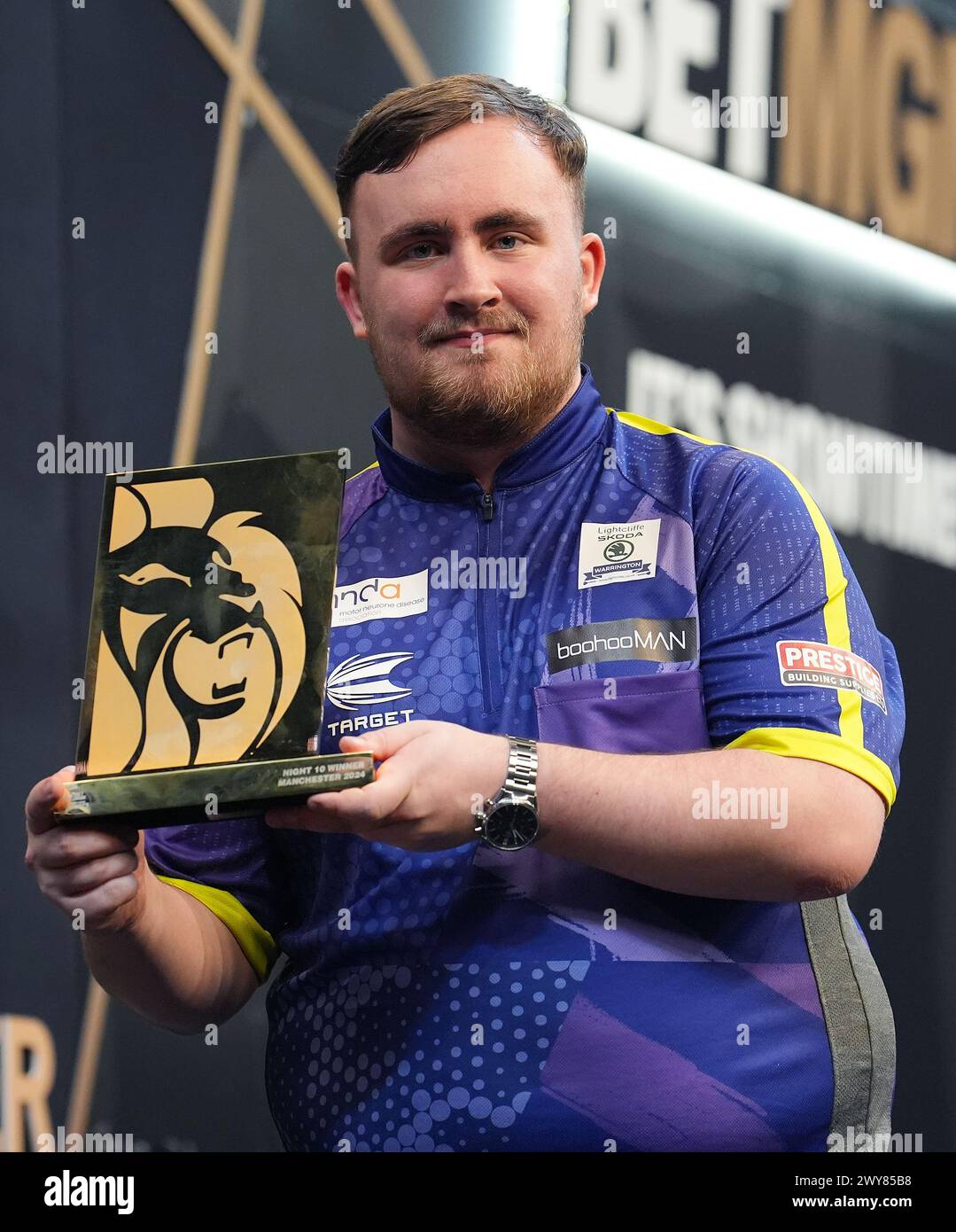 Luke Littler with the trophy after winning night ten of the 2024 BetMGM
