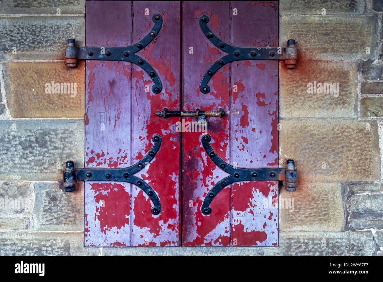 Wooden shutters with peeling paint and iron work Stock Photo - Alamy