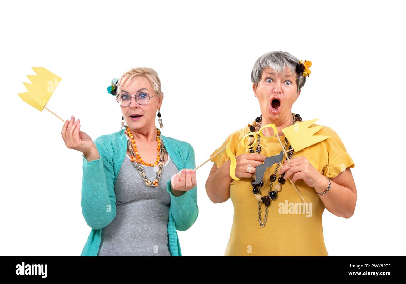 Friends senior portrait surprised with crowns and glasses isolated on white background Stock Photo