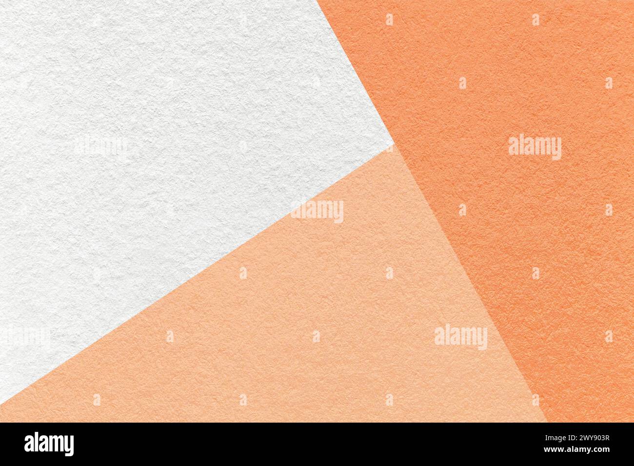 Color of year 2024. Texture of craft white, coral and peach fuzz shade color paper background, macro. Structure of vintage abstract cardboard with geo Stock Photo