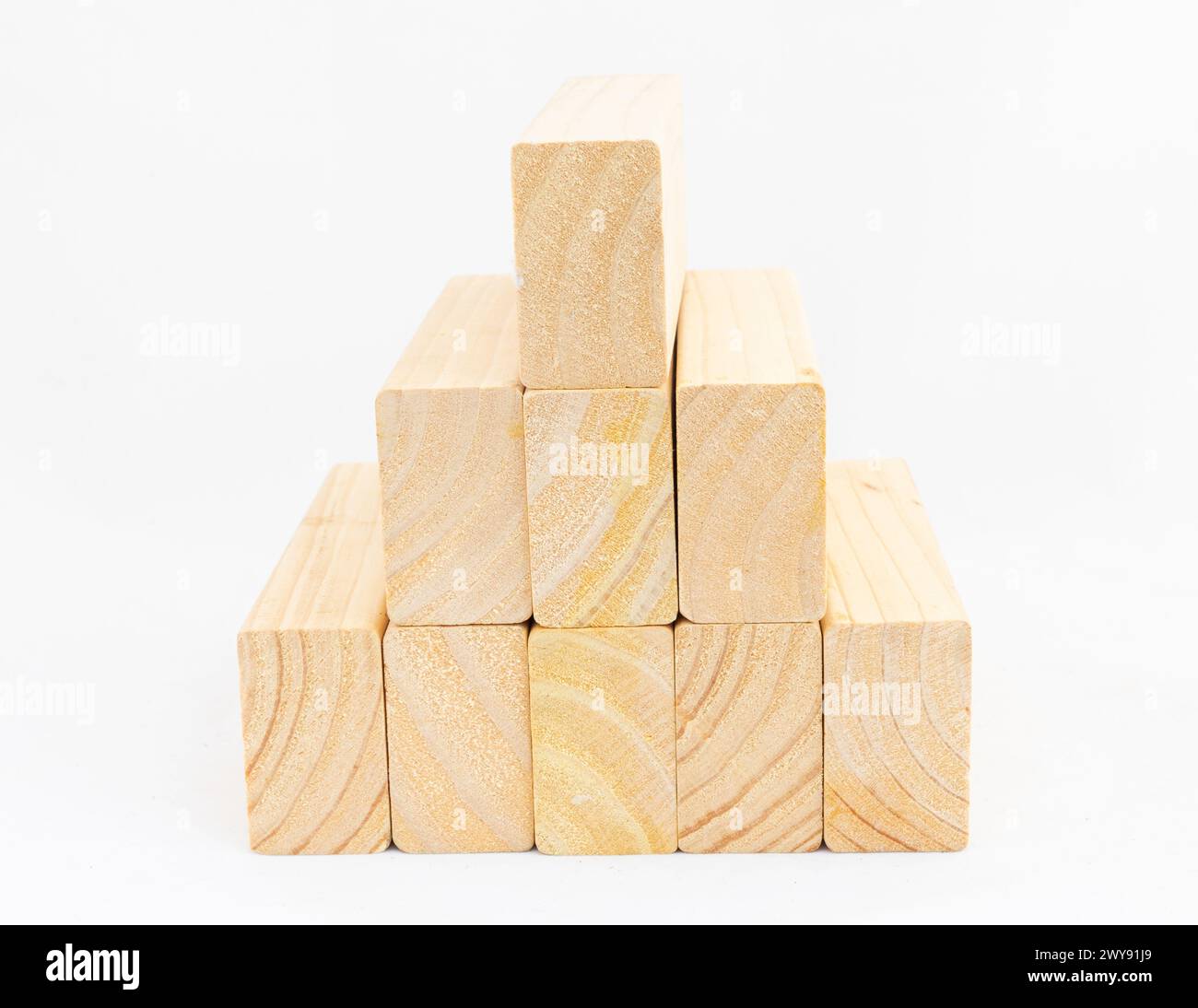 Stacked wood small planks in pyramid shape on white isolated background Stock Photo