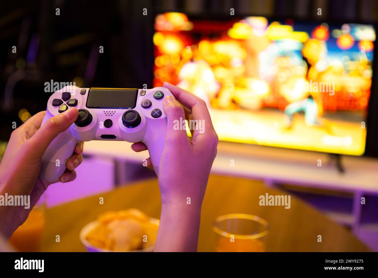 Close up one hand's woman player of video game on TV using joystick