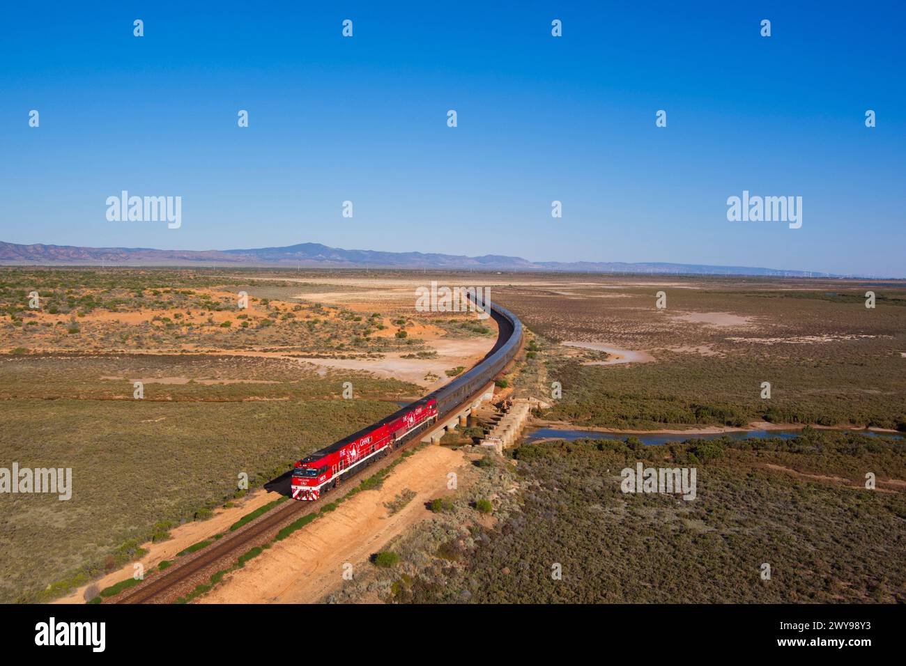 Aerial of The Ghan luxury passenger train crossing the wetlands near Port Augusta South Australia Stock Photo