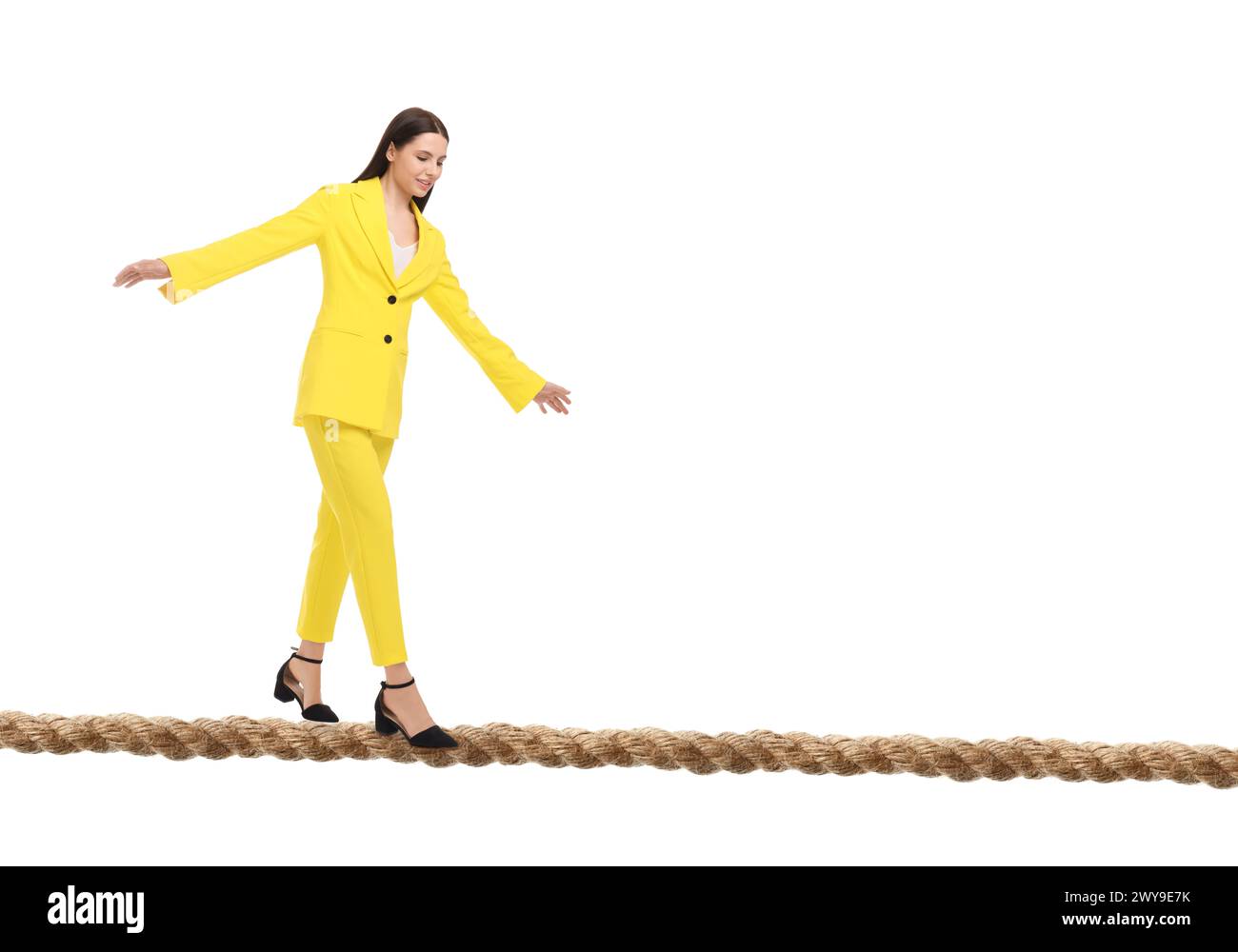 Businesswoman walking rope against white background. Risk or balance concept Stock Photo