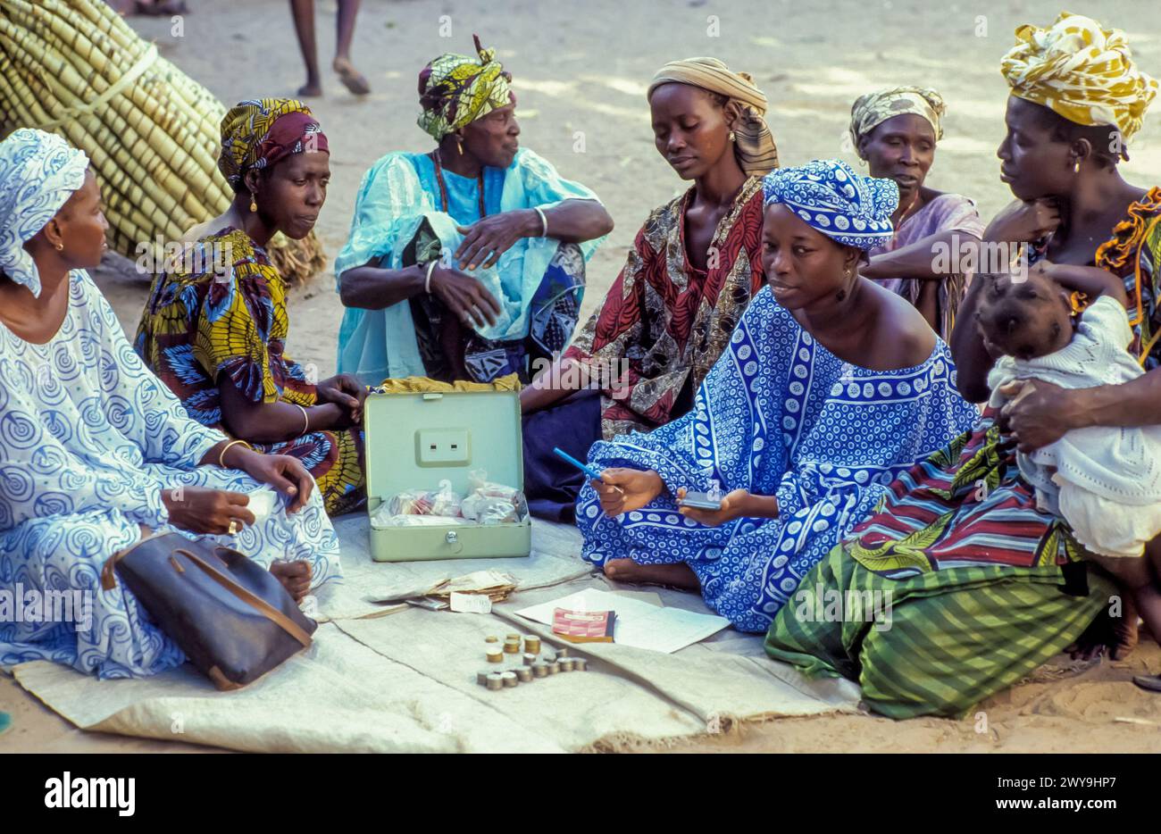 Senegal, Dakar, women count the money they earned from their agricultural cooperative, financed by a microcredit from a Dutch NGO. Stock Photo