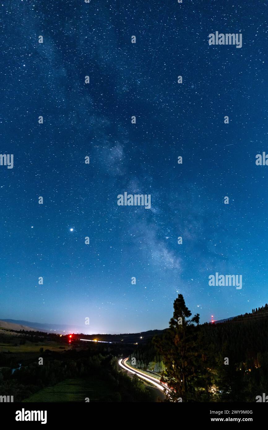 Night sky with stars and milky way galaxy over winding road Stock Photo ...