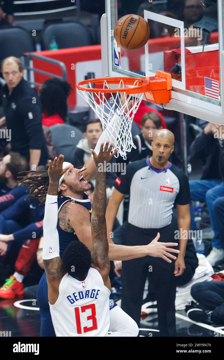 Los Angeles, United States. 04th Apr, 2024. Denver Nuggets's Aaron Gordon (Back) goes to the basket under pressure from Los Angeles Clippers' Paul George (Front) during an NBA basketball game at Crypto.com Arena. Clippers 102:100 Nuggets Credit: SOPA Images Limited/Alamy Live News Stock Photo