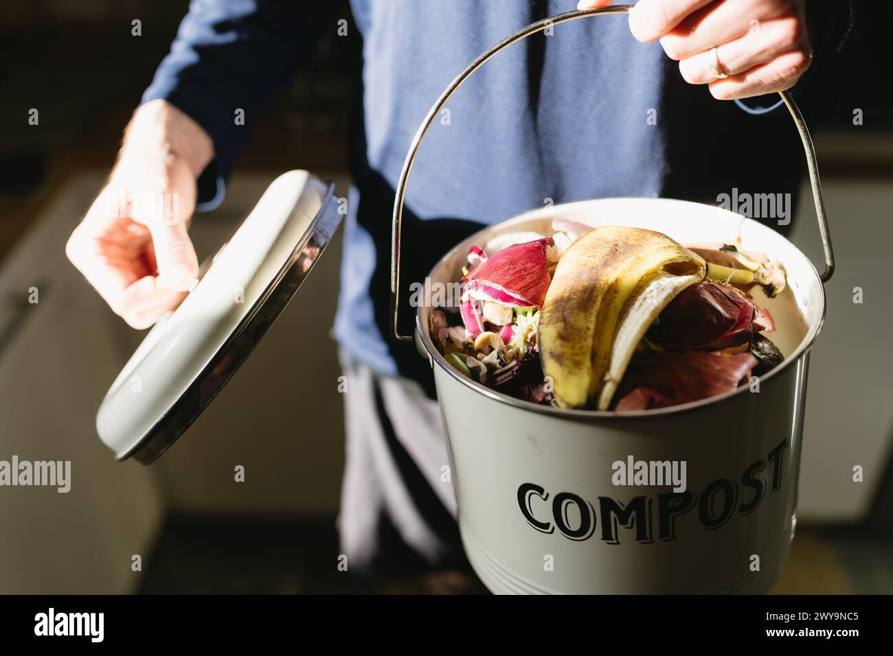 open compost bucket full of fruit and vegetable food scraps Stock Photo