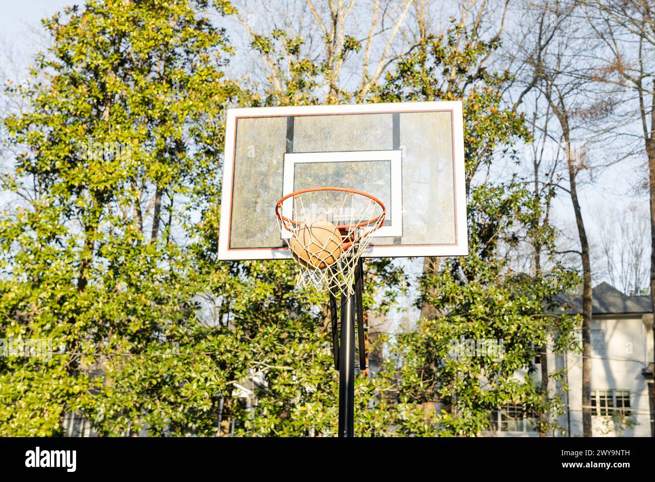 Basketball scoring in an outdoor hoop Stock Photo