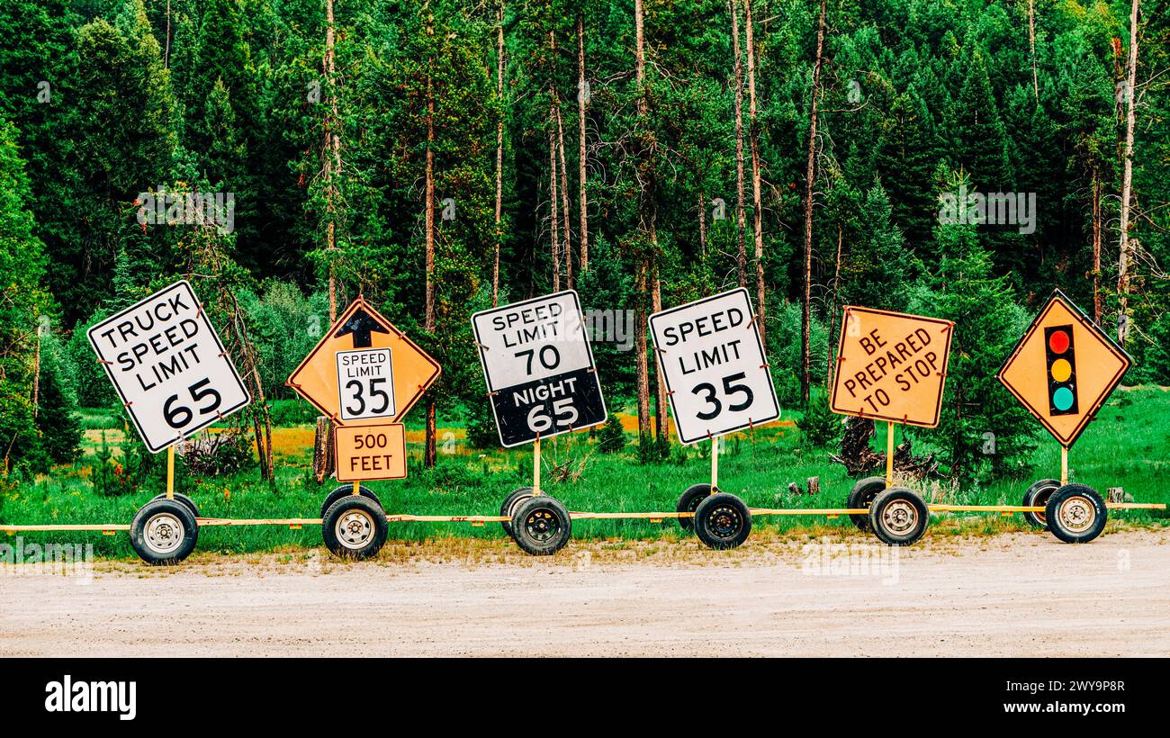 Row of lined up traffic safety signs on side of road Stock Photo