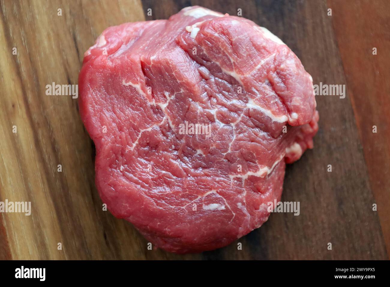 Prime filet mignon on a wooden board, ready for seasoning Stock Photo