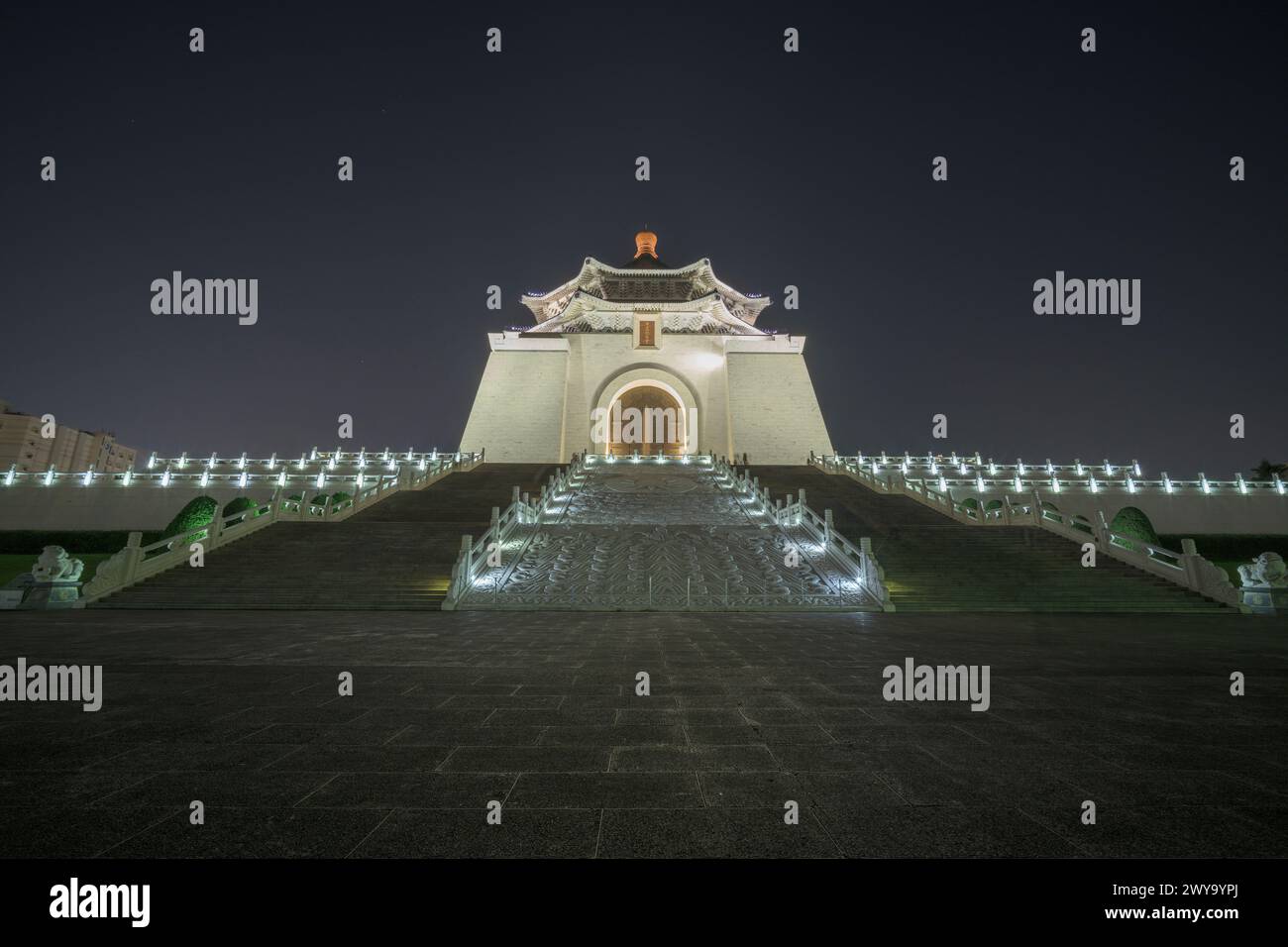 Front view of the Chiang Kai-shek Memorial Hall illuminated against the night sky Stock Photo