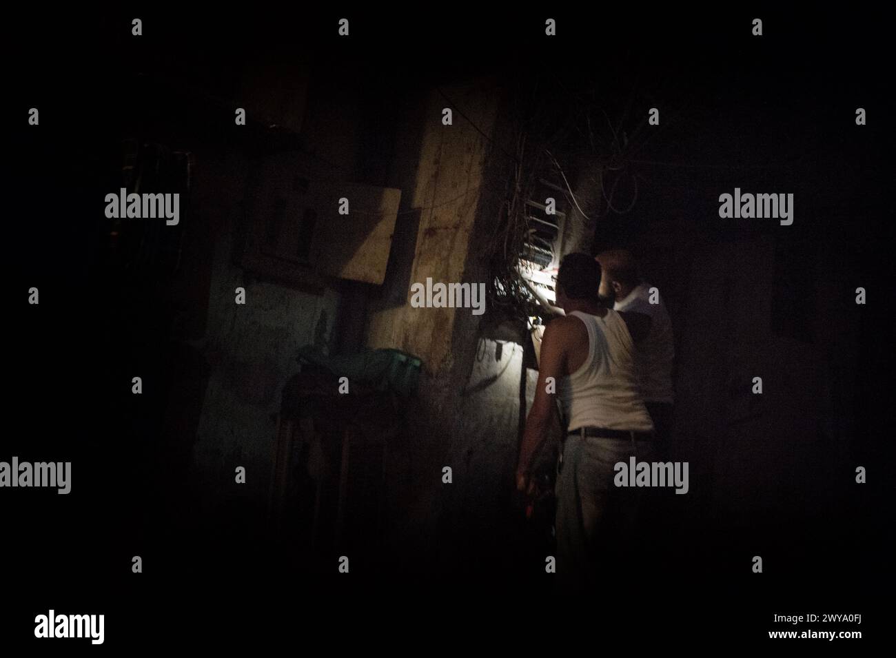 Electricians fixing the street wiring of the SabraShatila refugee camp