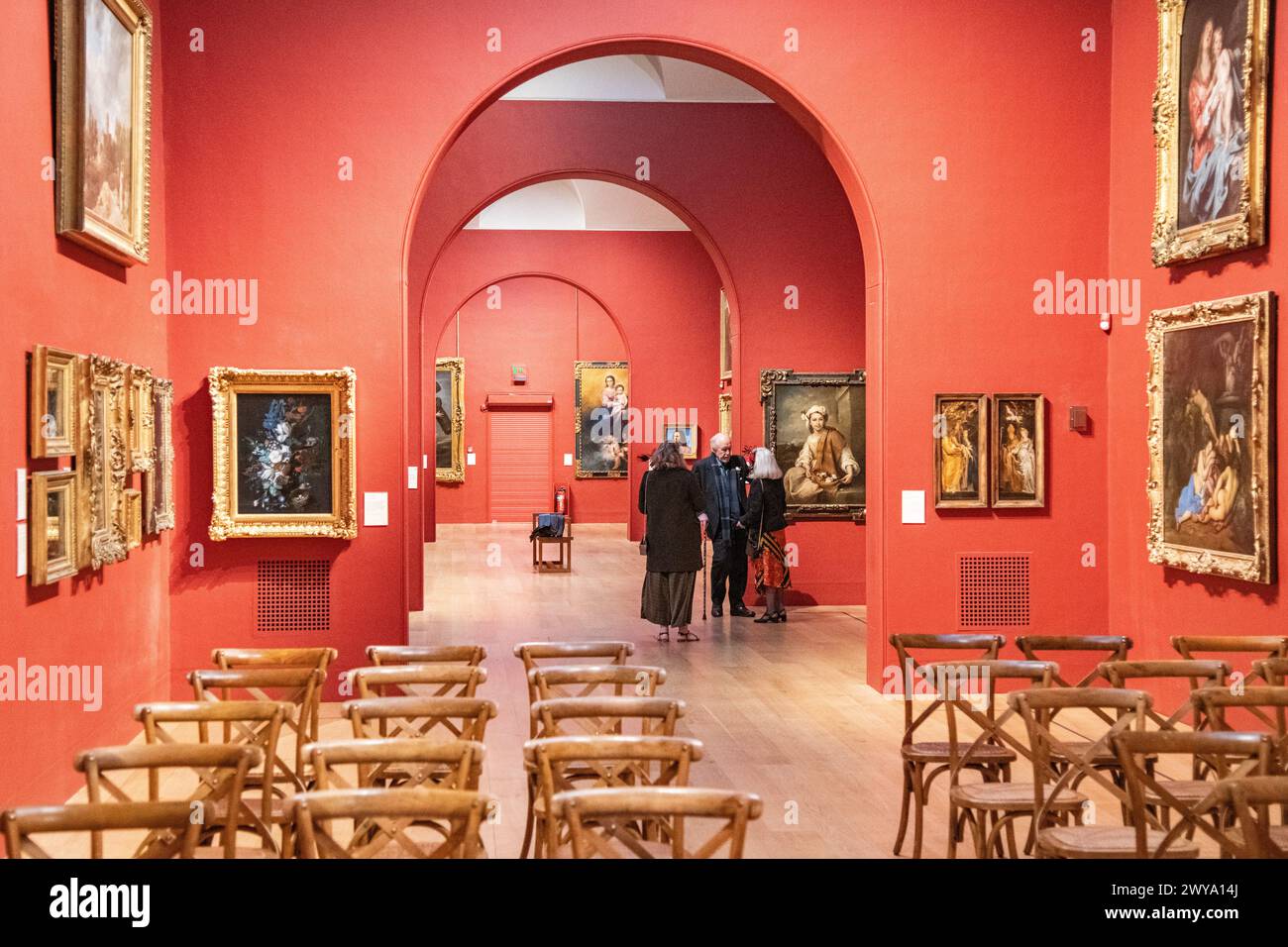 Wedding guests mingling and talking in the main gallery of Dulwich Picture Gallery in London, UK Stock Photo