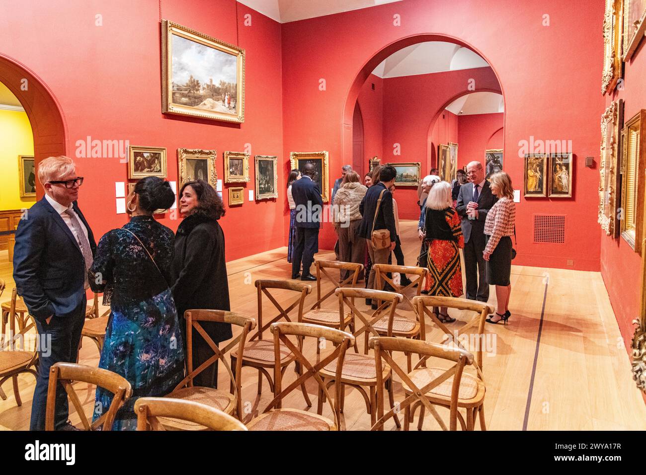 A group of wedding guests congregated in the main gallery of Dulwich Picture Gallery in London, UK Stock Photo